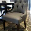 Custom made dining chair with tufted back and show-wood legs.